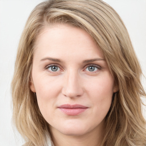 Joyful white young-adult female with long  brown hair and blue eyes