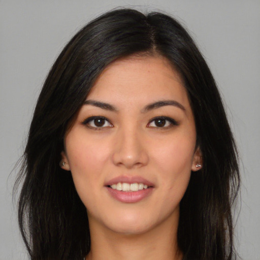 Joyful latino young-adult female with long  brown hair and brown eyes