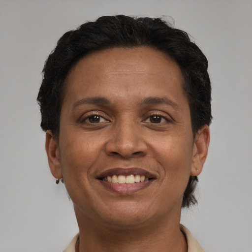 Joyful black adult female with short  brown hair and brown eyes