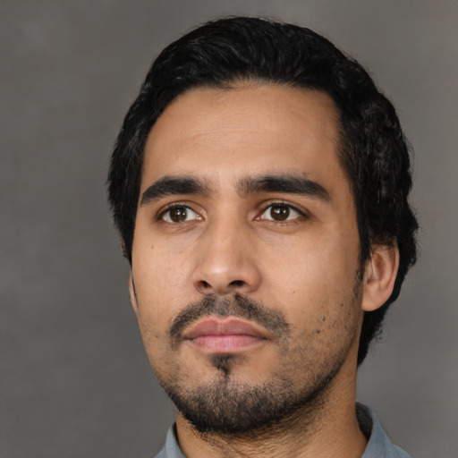 Neutral latino young-adult male with short  black hair and brown eyes
