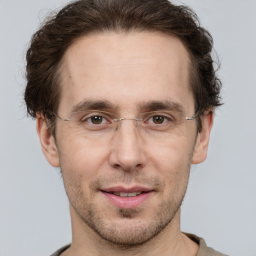 Joyful white adult male with short  brown hair and grey eyes