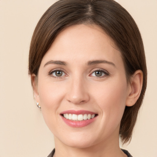 Joyful white young-adult female with medium  brown hair and brown eyes