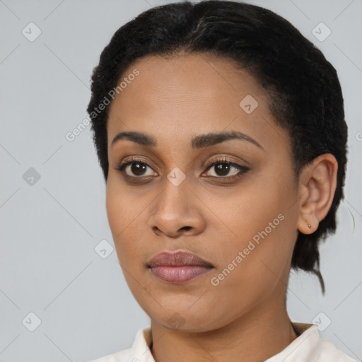 Joyful black young-adult female with short  black hair and brown eyes