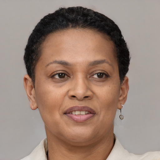 Joyful latino adult female with short  brown hair and brown eyes
