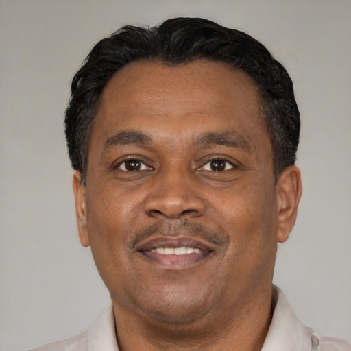 Joyful latino adult male with short  black hair and brown eyes