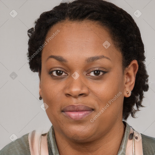 Joyful black adult female with short  brown hair and brown eyes