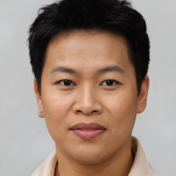 Joyful asian young-adult male with short  brown hair and brown eyes