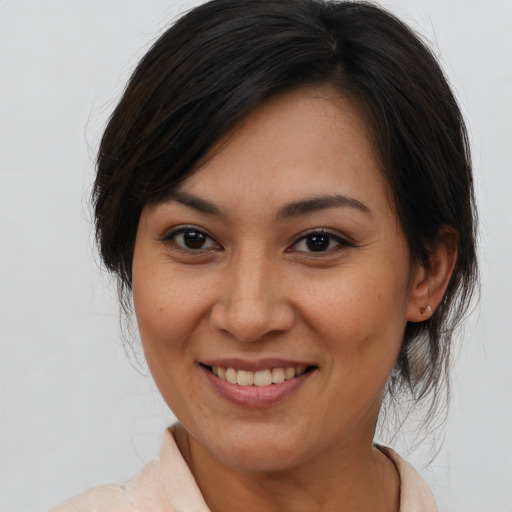Joyful asian young-adult female with medium  brown hair and brown eyes