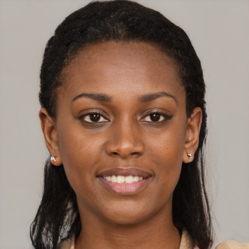 Joyful black young-adult female with medium  brown hair and brown eyes