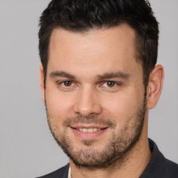 Joyful white young-adult male with short  brown hair and brown eyes