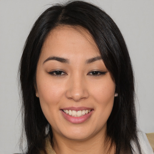 Joyful asian young-adult female with long  black hair and brown eyes