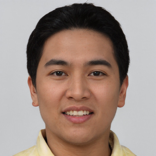 Joyful latino young-adult male with short  black hair and brown eyes