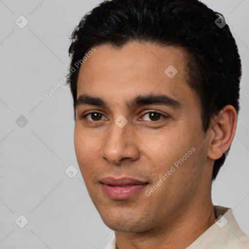 Joyful latino young-adult male with short  black hair and brown eyes