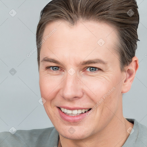 Joyful white adult male with short  brown hair and grey eyes