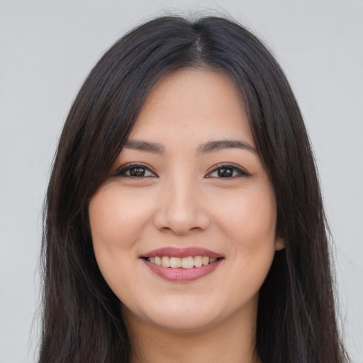Joyful asian young-adult female with long  brown hair and brown eyes
