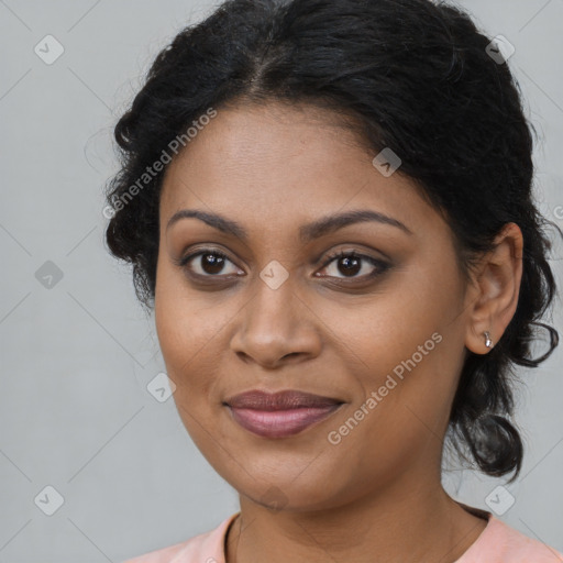 Joyful black young-adult female with long  brown hair and brown eyes