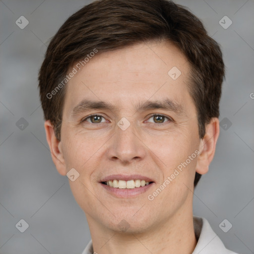 Joyful white young-adult male with short  brown hair and grey eyes