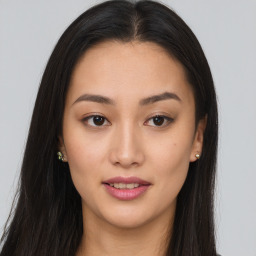 Joyful asian young-adult female with long  brown hair and brown eyes