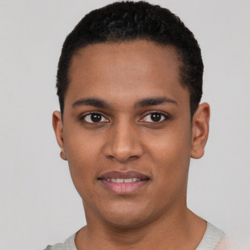 Joyful black young-adult male with short  black hair and brown eyes