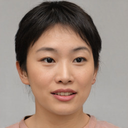 Joyful asian young-adult female with medium  brown hair and brown eyes