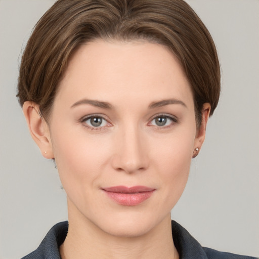 Joyful white young-adult female with short  brown hair and grey eyes