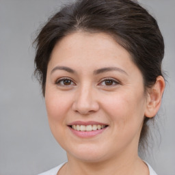 Joyful white young-adult female with medium  brown hair and brown eyes