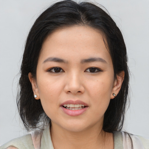Joyful asian young-adult female with medium  brown hair and brown eyes