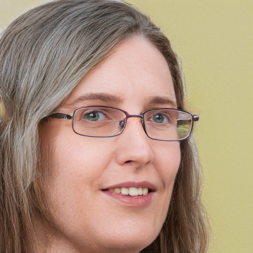 Joyful white adult female with long  brown hair and grey eyes