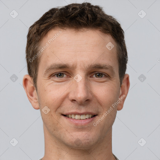 Joyful white adult male with short  brown hair and grey eyes