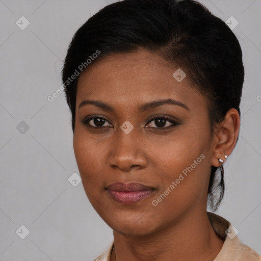 Joyful black young-adult female with short  brown hair and brown eyes