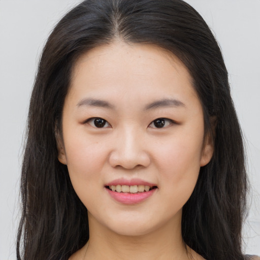 Joyful asian child female with long  brown hair and brown eyes
