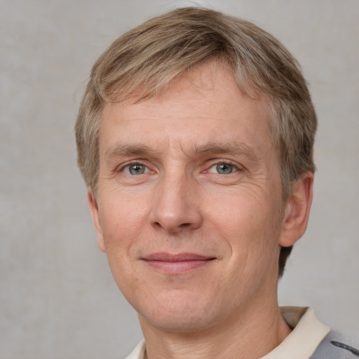 Joyful white adult male with short  brown hair and grey eyes