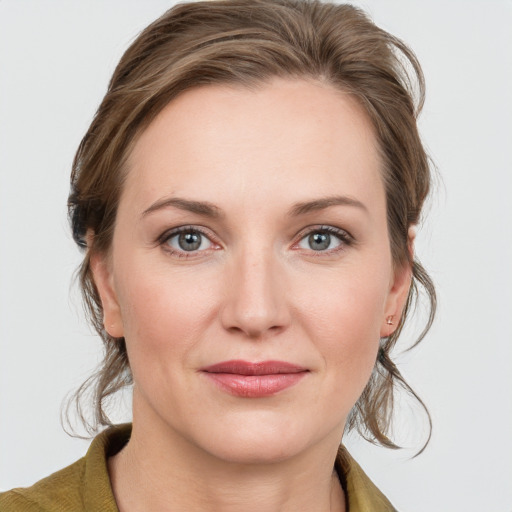 Joyful white young-adult female with medium  brown hair and blue eyes