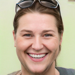 Joyful white adult female with short  brown hair and grey eyes