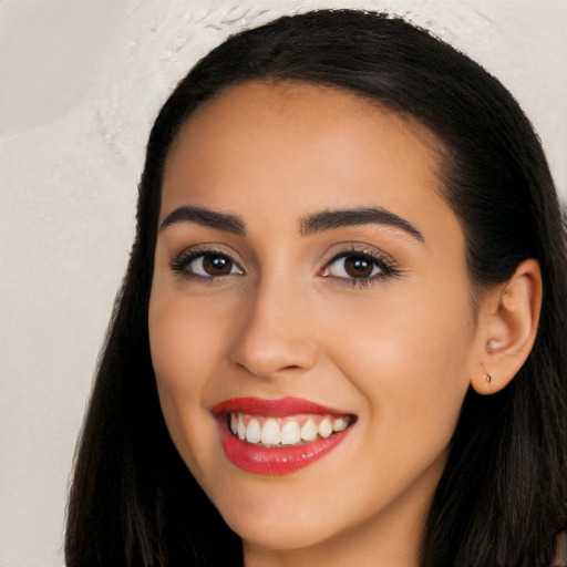 Joyful latino young-adult female with long  black hair and brown eyes