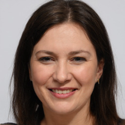 Joyful white adult female with medium  brown hair and brown eyes