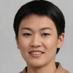 Joyful asian young-adult female with short  black hair and brown eyes