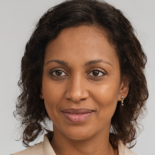 Joyful black young-adult female with medium  brown hair and brown eyes