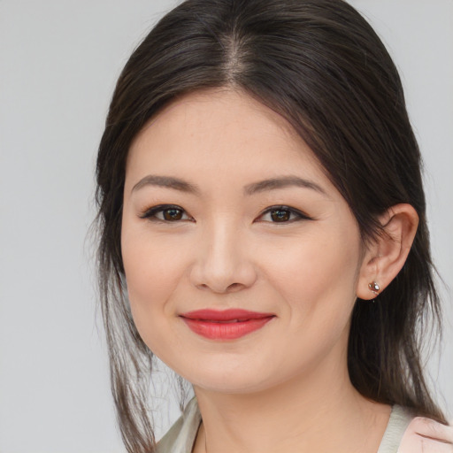 Joyful asian young-adult female with medium  brown hair and brown eyes