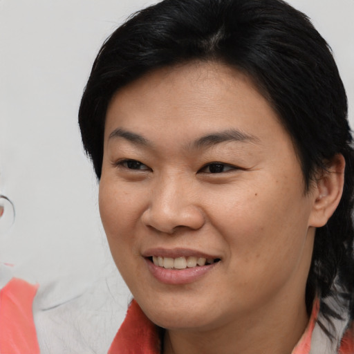 Joyful asian young-adult female with medium  brown hair and brown eyes