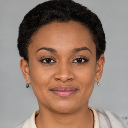 Joyful black young-adult female with short  brown hair and brown eyes