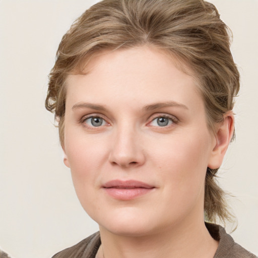 Joyful white young-adult female with medium  brown hair and blue eyes