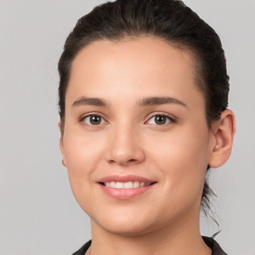 Joyful white young-adult female with short  brown hair and brown eyes