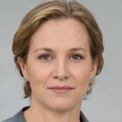 Joyful white adult female with medium  brown hair and grey eyes