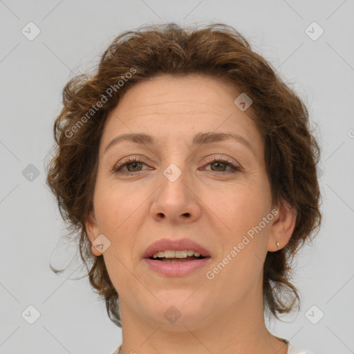 Joyful white adult female with medium  brown hair and green eyes