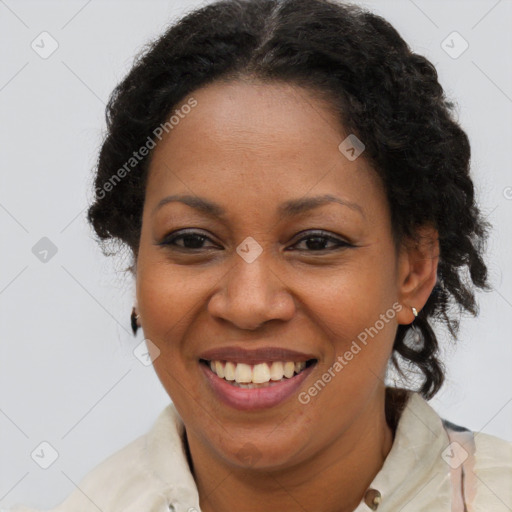 Joyful black adult female with short  brown hair and brown eyes