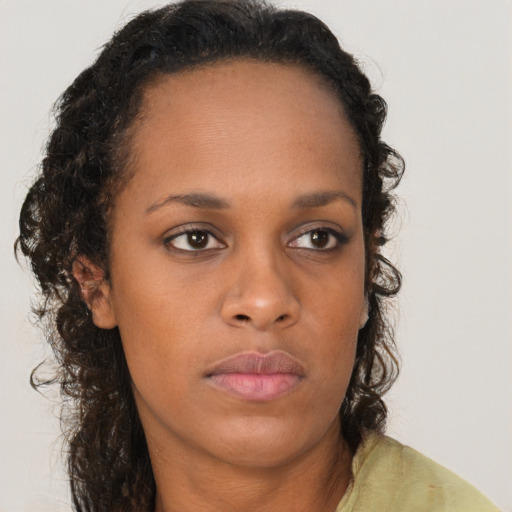 Neutral black young-adult female with long  brown hair and brown eyes