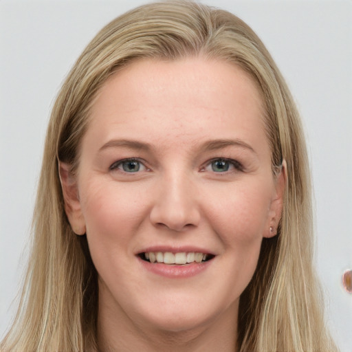 Joyful white young-adult female with long  brown hair and blue eyes