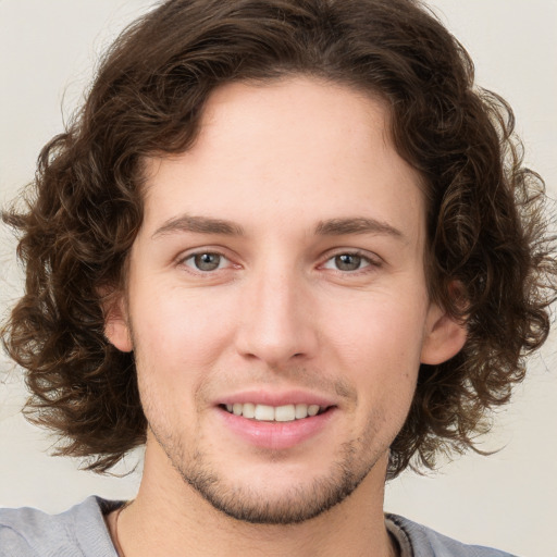 Joyful white young-adult male with medium  brown hair and brown eyes