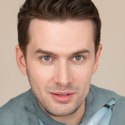 Joyful white young-adult male with short  brown hair and grey eyes